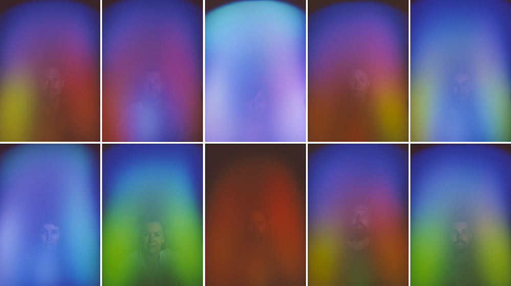 A grid of 10 faint portraits of people each covered in different vibrant washes of blue, purple, green, blue and red hues.