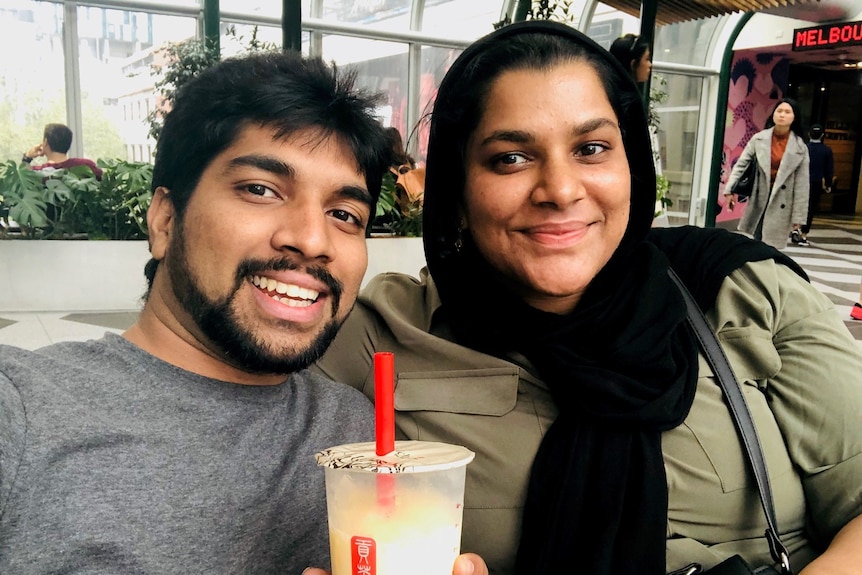 Seeni and Shameina sit relaxing in Melbourne with a drink. 