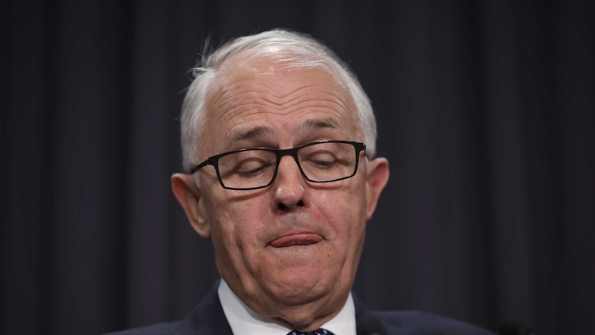 Malcolm Turnbull with his tongue between pursed lips in Parliament House in August 2018