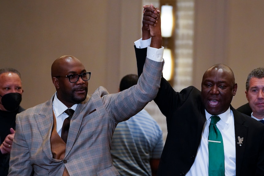 Philonise Floyd and Attorney Ben Crump react after a guilty verdict was announced.