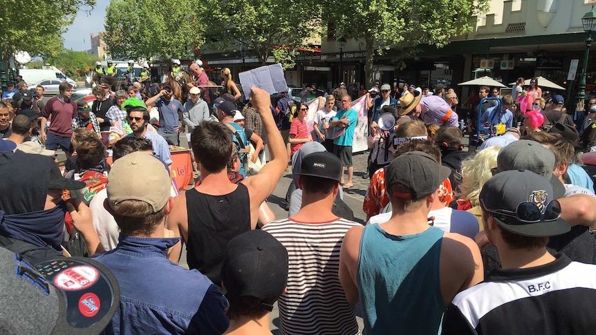 Crowds gather in Bendigo as mounted police standby.