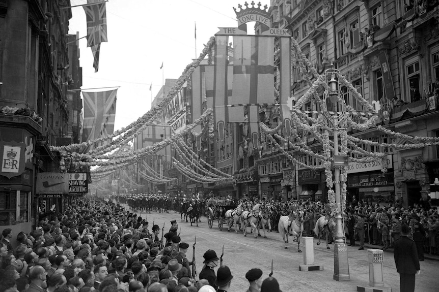 A black and white photo shows crowds in the streets for Elizabeth's coronation in 1953.