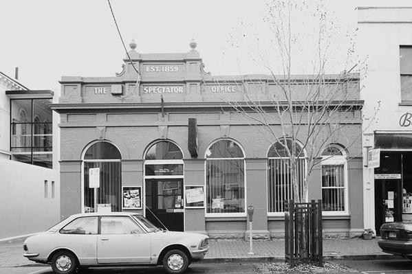 Black and white historical image of a building signposted 'the Spectator office'.
