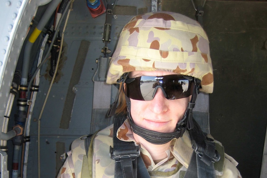 Sally Heidenreich seated in a Black Hawk helicopter in Afghanistan.