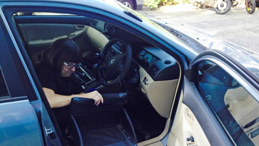 Mel Harrison putting her wheelchair in her car