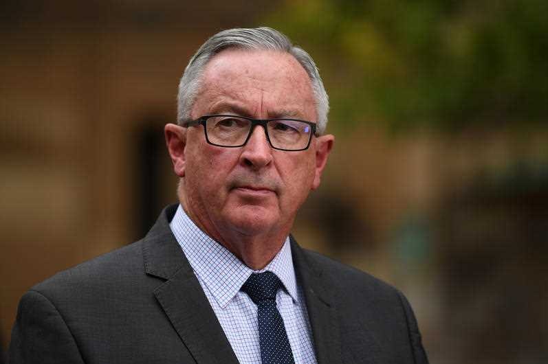 A man with grey hair and glasses.