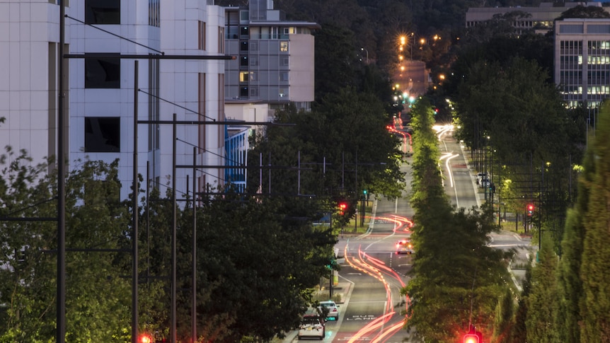 Constitution Avenue at night with lights from cars passing through.