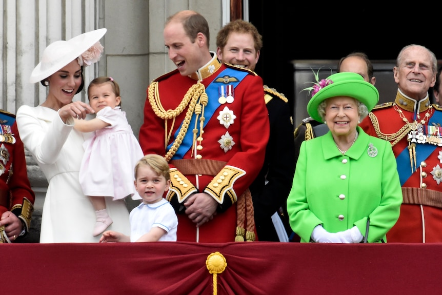 Members of the British royal family stand on the balcony of Buckingham Palace.