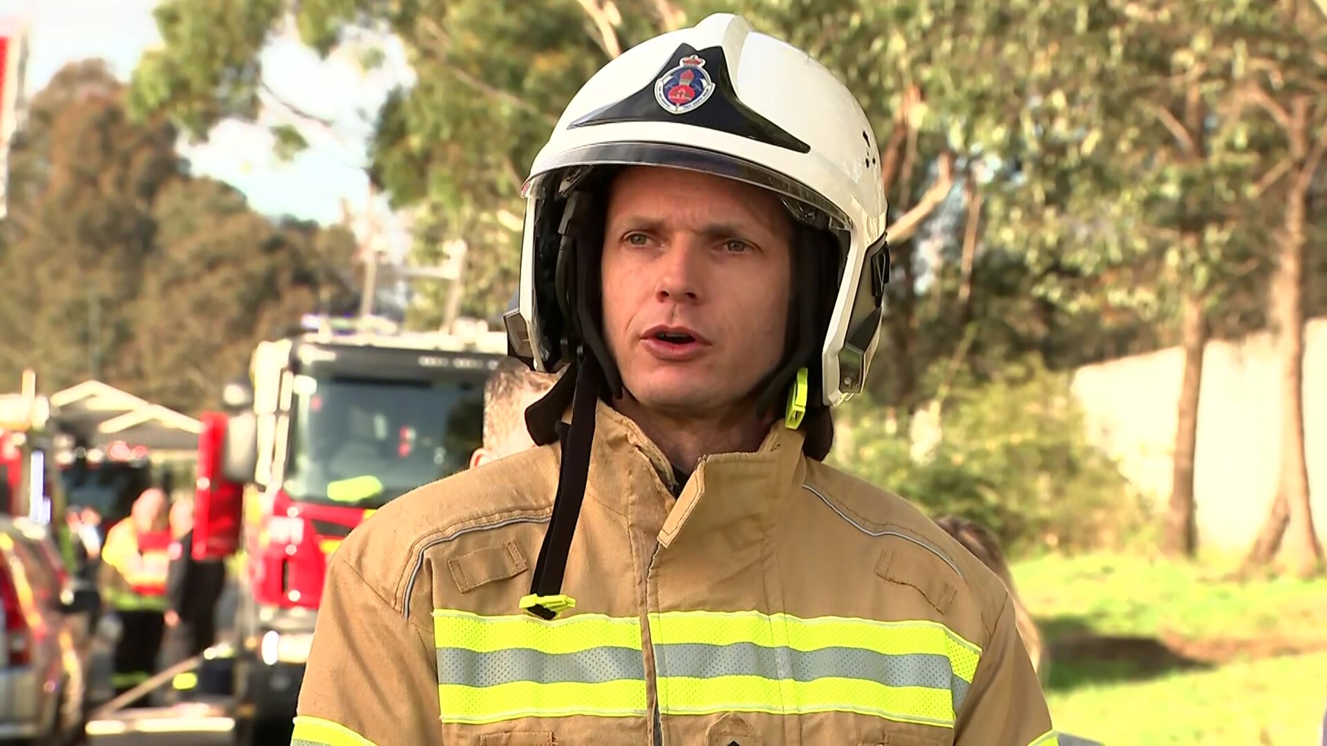 A man wearing a helmet and firefighters uniform