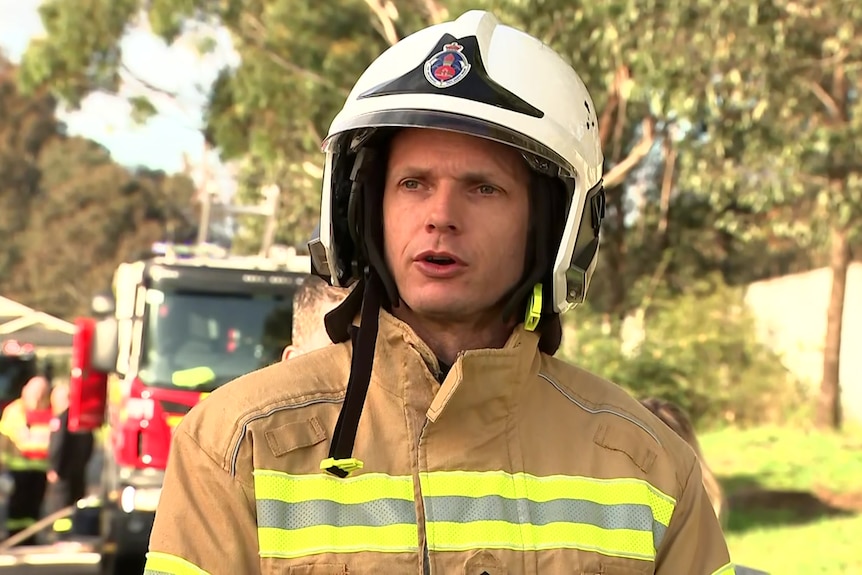 A man wearing a helmet and firefighters uniform