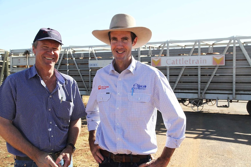 Quilpie Mayor Stuart McKenzie (L) and livestock buyer Bill Burton in front of the cattle train.