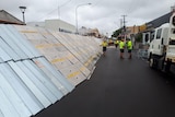 A large flood barrier is built on a city street.
