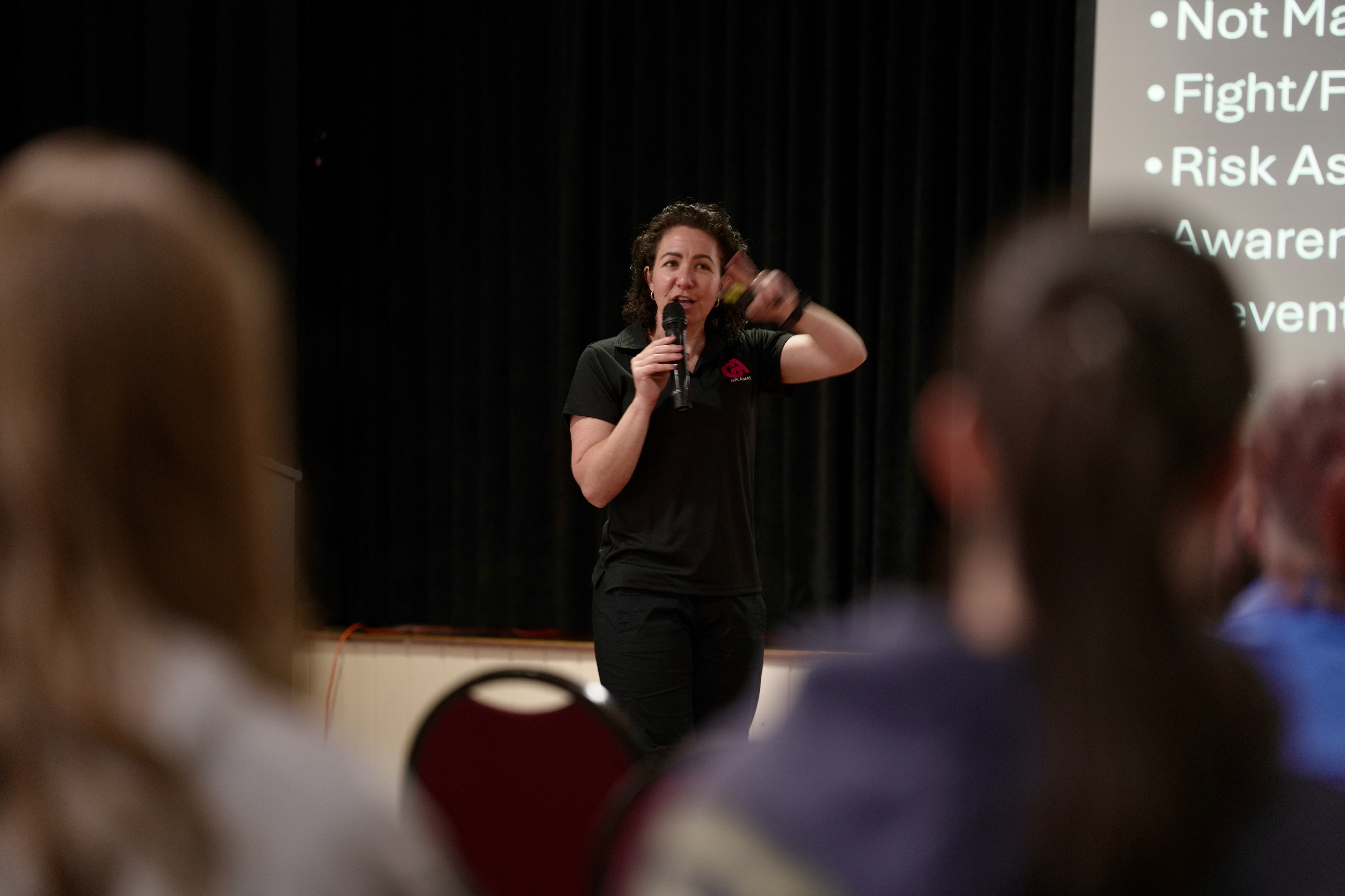 a woman speaks into a microphone