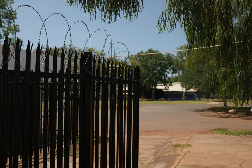 A security fence and barbed wire on a property boundary