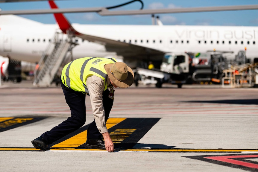 Employee working on a runway at Brisbane Airport
