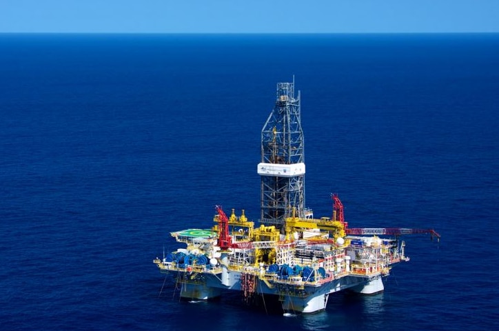 A long shot of a Chevron gas platform at sea.