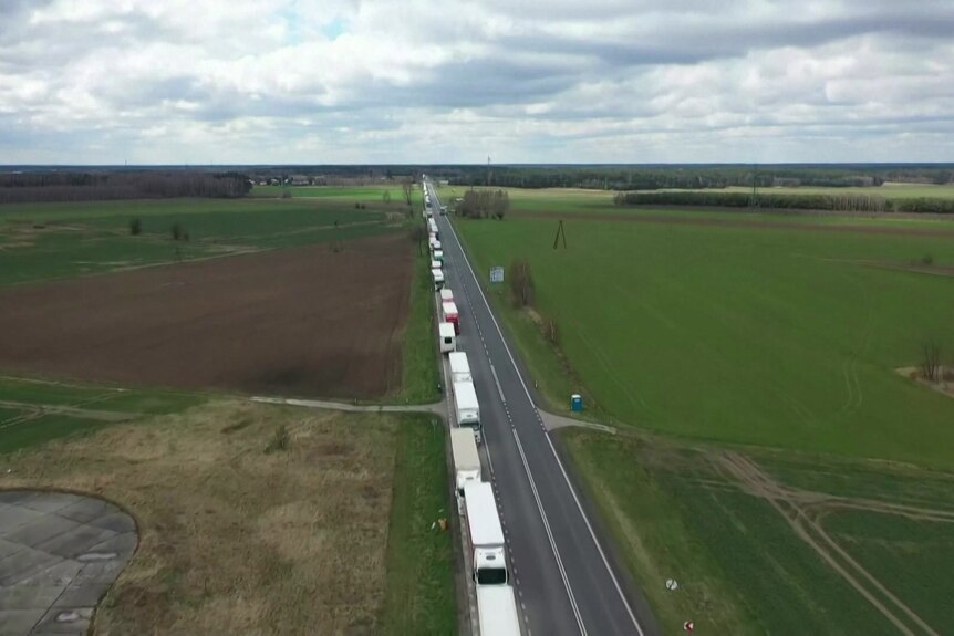 A long line of trucks on a road