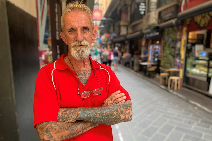 John Tjepkema stands with his arms crossed in front of a Melbourne lane.