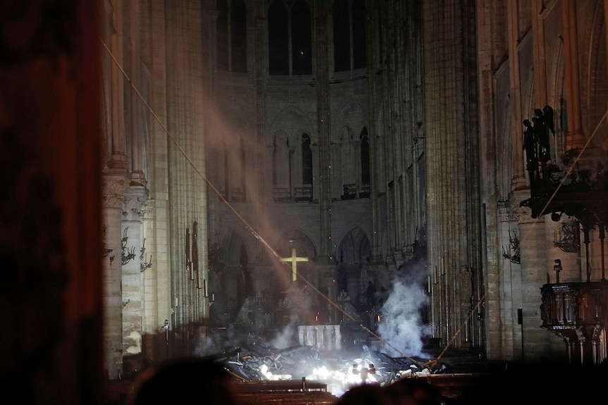 Smoke is seen in the interior of Notre Dame cathedral in Paris, Monday, April 15, 2019.