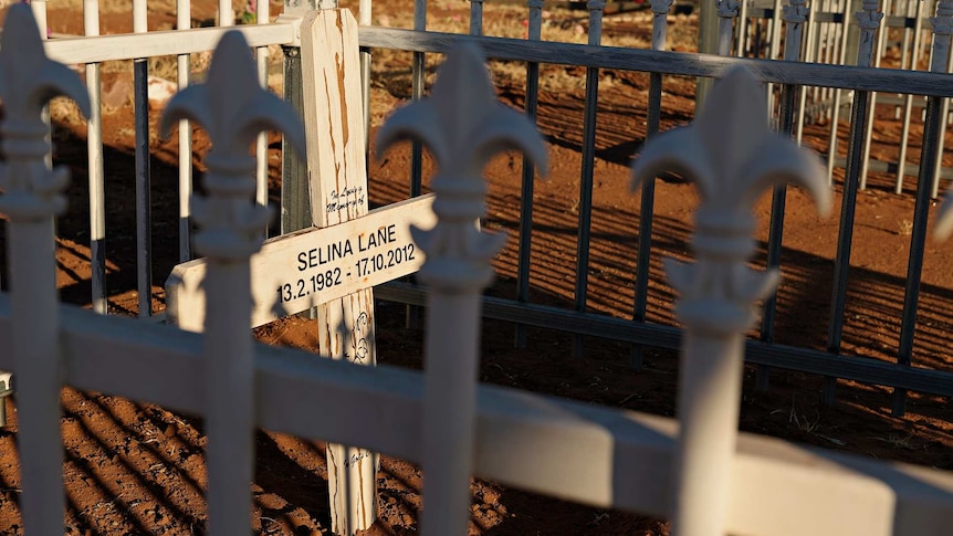 White wright iron fence posts surround the grave of Selina Lane.