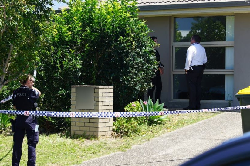 Police outside home with police tape.