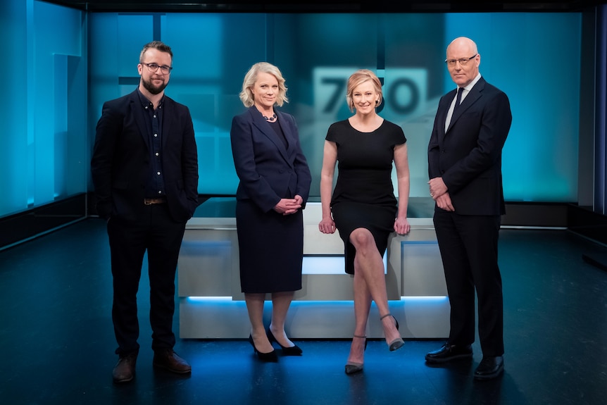 Two men and two women in TV studio with 7.30 log in background.