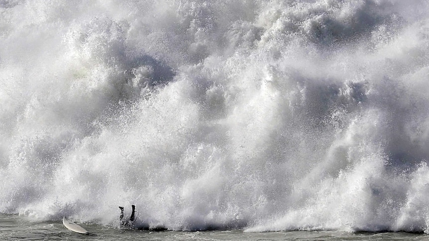 Surfer falls in Big Wave World Tour event.