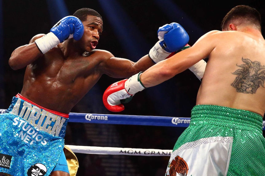 Adrien Broner (blue gloves) moves in to land punches on Carlos Molina in Las Vegas in 2014.