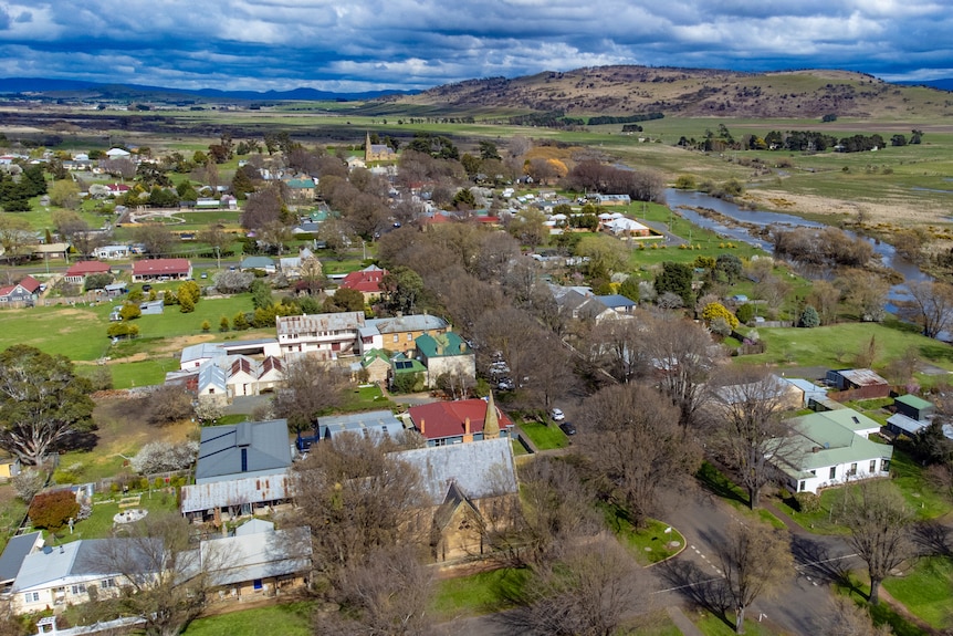 An aerial view shows the church amongst the township.