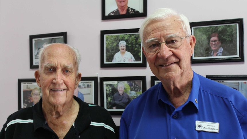 Head and shoulders photograph of two men standing together