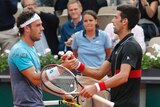 Italy's Marco Cecchinato (L), is congratulated by Serbia's Novak Djokovic at the French Open.