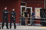 Policemen stand in front of a McDonald's restaurant in Munich.