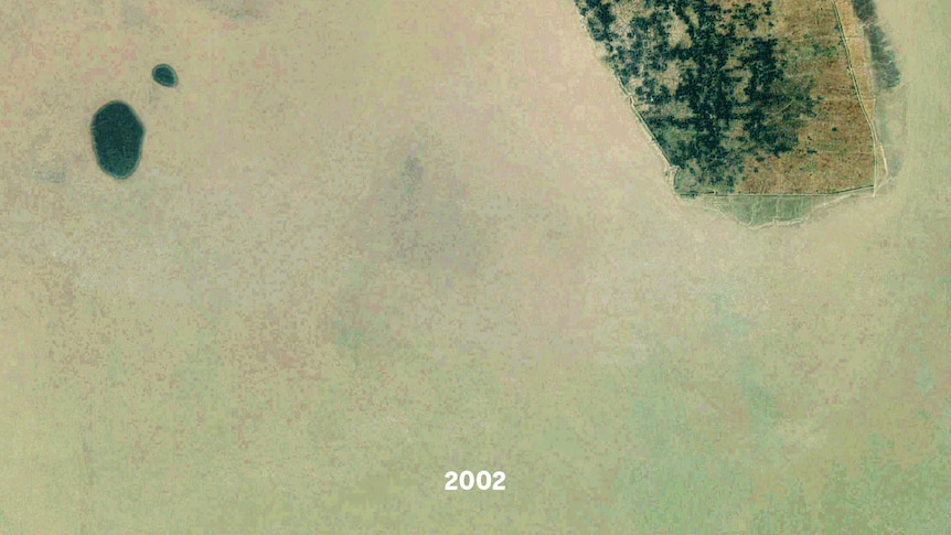 A satellite images of a small island, part of it is underwater