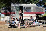 Tina, Sam, Amelie and Simon Storey (from left) standing out the front of their small caravan.