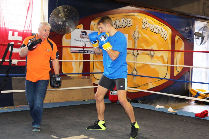 Boxer David Toussaint training in the ring with his coach Garry Hamilton.