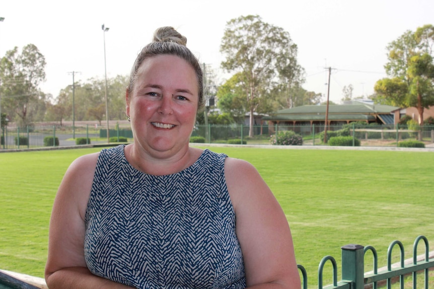 Natalie Thurston pictured at Walgett's "Sporties" Club with lawn bowl greens in the background.
