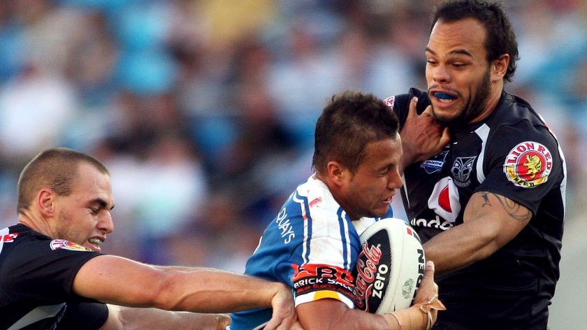 Master of ceremonies... Scott Prince attempts to push away from the Warriors' defence.