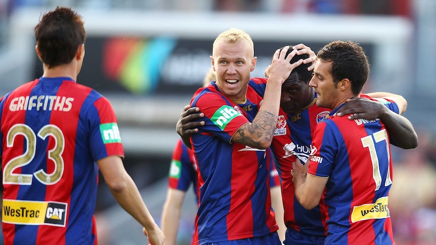 Jets' team-mates congratulate marquee player Emile Heskey after he was awarded a free kick.
