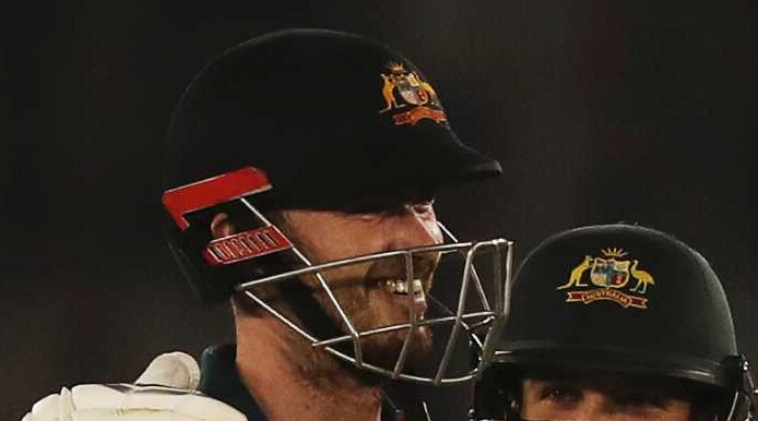 Ashton Turner and Jhye Richardson hug as Virat Kohli and Jasprit Bumrah walk off in the foreground