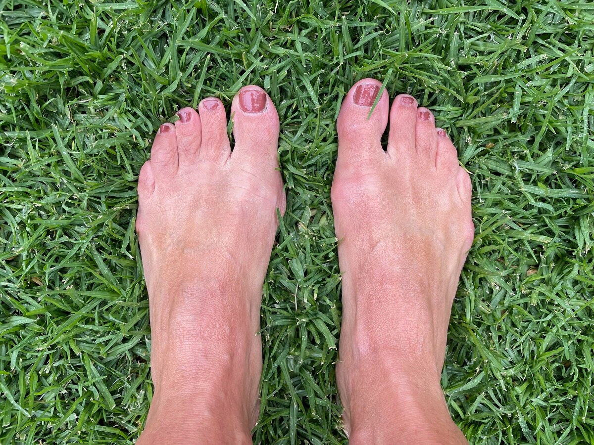 Monica's feet standing on green grass