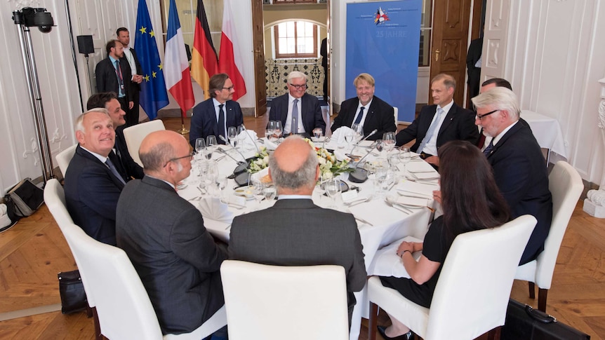 Foreign ministers from Germany, Poland and France sit around a table.