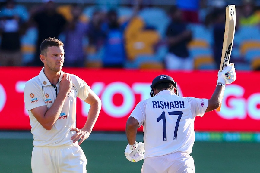 India’s Rishabh Pant raises his arm as he runs as he celebrates the winning races against Australia.