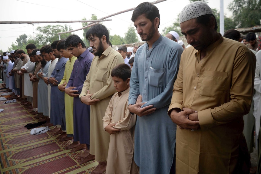 Afghan refugees offer Eid al-Adha prayers at a mosque in Peshawar, Pakistan.