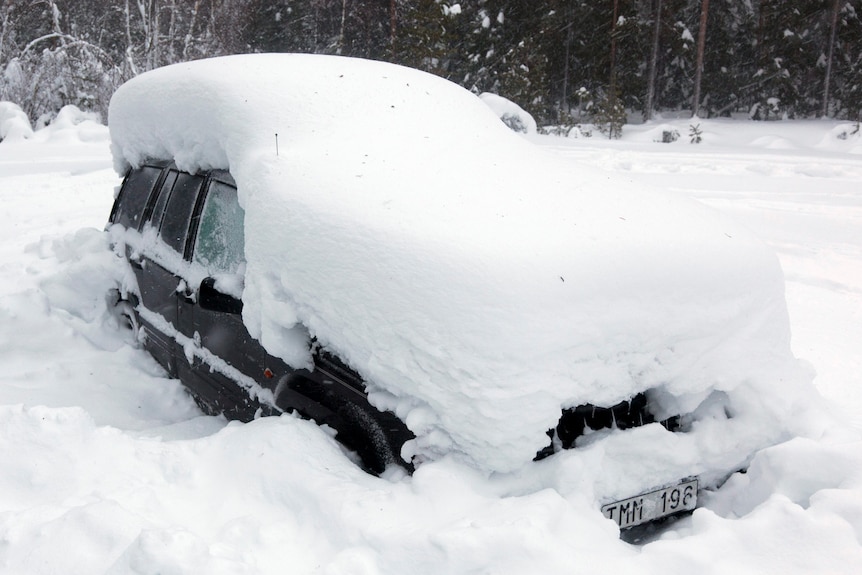 A snowed-in car is seen in the woods north of Umea in northern Sweden