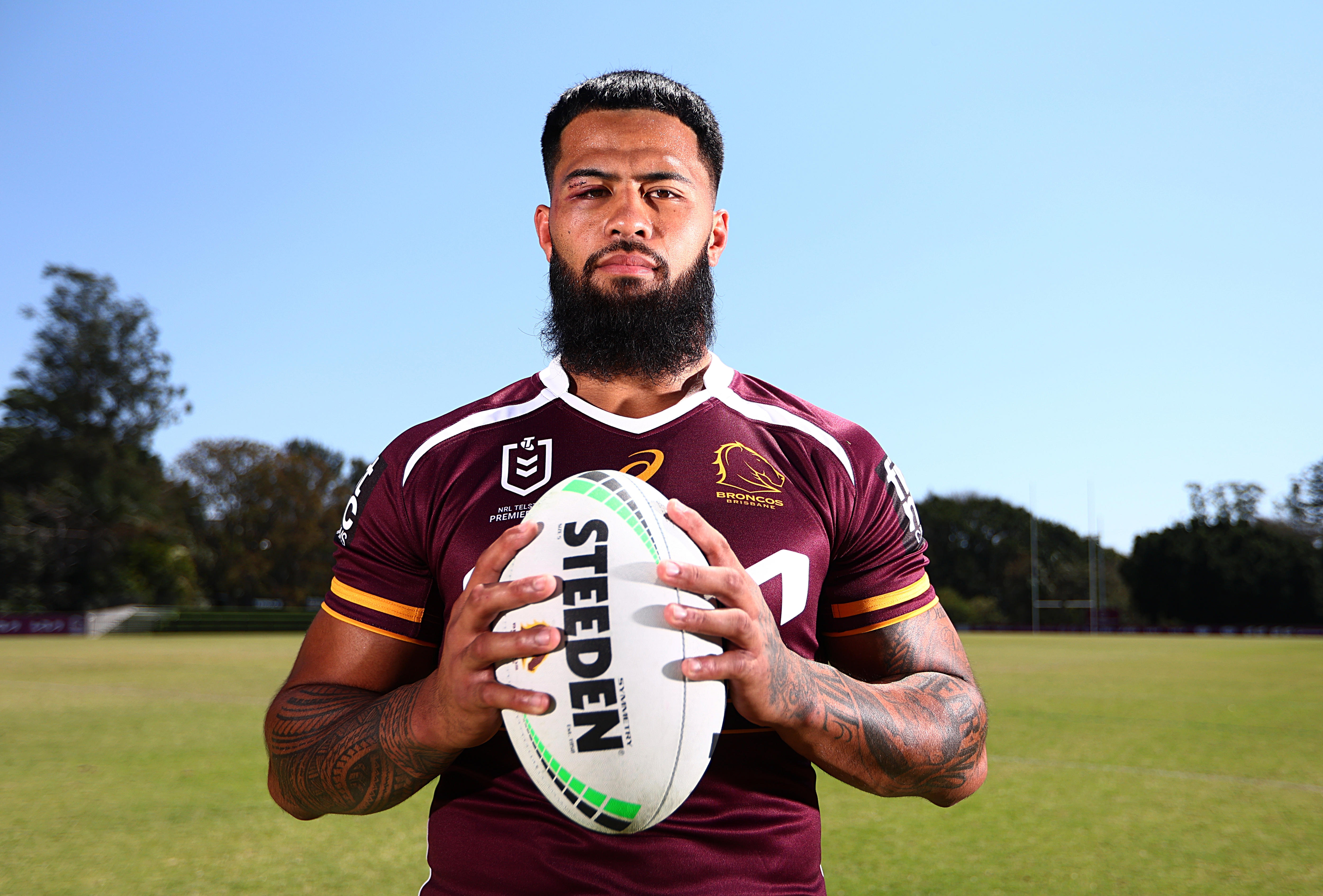 Payne Haas poses with a football during a photoshoot