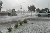 A storm picture shows hail falling on a residential street in Lockyer Valley