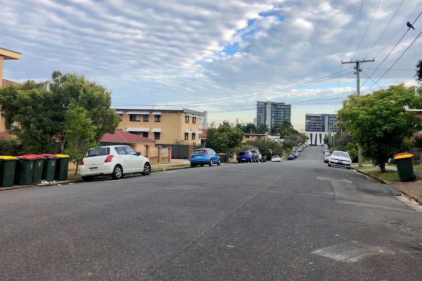 Cars on a wide street in a suburb in Brisbane.