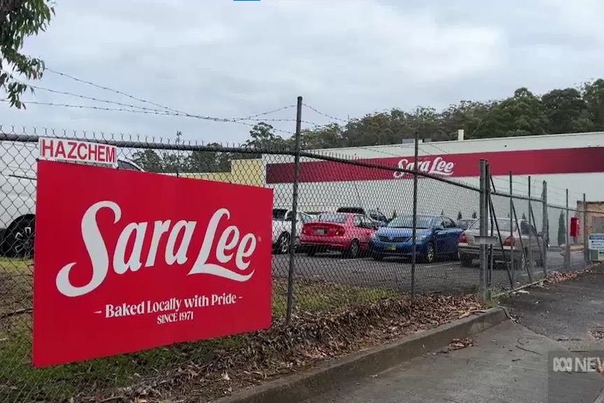 A carpark with the branding for Sara Lee on a fence 