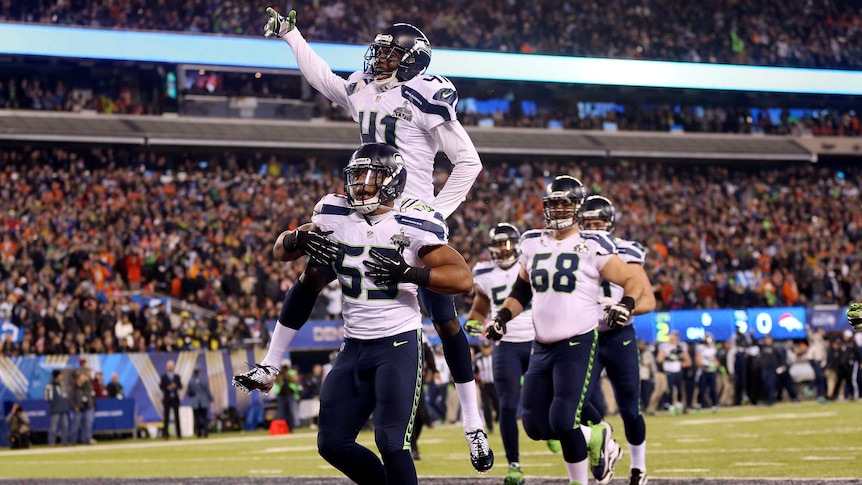 Malcolm Smith (53) celebrates a touchdown for Seattle against Denver in Super Bowl XLVIII.