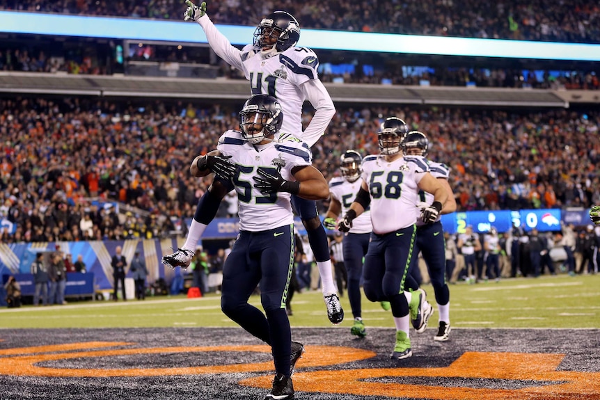 Malcolm Smith (53) celebrates a touchdown for Seattle against Denver in Super Bowl XLVIII.